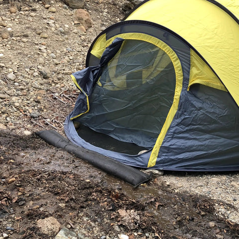 Water Activated Flood Barrier 5 Feet Pack Black protecting tent from water by diverting flow, flexible design against ground