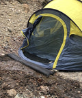 Water Activated Fast Acting Flood Barriers 26 Pack Black in front of tent, no sand or labor needed, expands to 3.5 inches in minutes