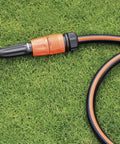 Heavy Duty Quick Connect Hose Fittings Half Inch Female Rubber Stop Coupling on green grass, designed for easy garden irrigation.