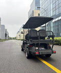 Bad Boy Six Seater Golf Cart And Sightseeing Patrol Wagon parked on a smooth road with a sleek design and weatherproof canopy.