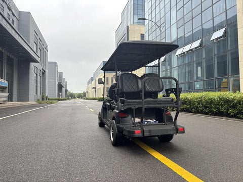 Bad Boy Six Seater Golf Cart And Sightseeing Patrol Wagon parked on a smooth road with a sleek design and weatherproof canopy.