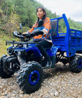 Person sitting on an ATV carrying a Heavy Duty Utility Trailer With Bucket For Tractor And ATV Use, all-terrain hauler.