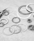 Beefy Heavy-Duty Thrust Needle Roller Bearing Set With Washers, Chrome Steel Precision Cage, NTA4052 components on gray background