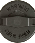Top view of OE Equivalent Fuel Tank Cap 31748 For Vehicles Zinc Plated Fenderwell Style With Dichromate Dip featuring warning label.