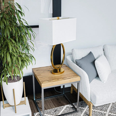 Oke Table Lamp With Gold Plated Finish, Modern Art Deco Open Round Frame, White Rectangular Shade on a wooden side table.