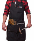 Man wearing Heavy Duty Waxed Canvas Apron for Men and Women, Adjustable Crossback with Tool Pockets, Water Resistant and Oil Proof, Black.