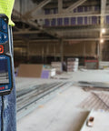 Person wearing Super Handy 165 Foot Blaze Laser Distance Measure With Backlit Color Display on belt at construction site
