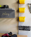 Cordless Drill Tool Organizer Wall Mount Charger and Storage Rack for Garage Organization, installed with tools on pegboard.