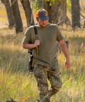 Hunter using Baktrak Traction Web Rifle Sling 36 Inch With 500Lb Swivels Slim Non Slip Pad Tan Black for easy carry.