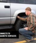 Man attaching Waterproof Magnetic Key Box For Spare Keys With Secure Magnetic Key Holder to truck wheel well for hidden storage