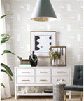 Room with Nikki Chu Zulu Signature Peel And Stick Vinyl Wallpaper Roll for easy no mess install, featuring white drawers and decor