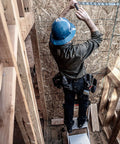 Worker on Jumbo Step Aluminum 2 Step Stool Ladder, Lightweight Yet Sturdy With A 375 Pound Duty Rating, hammering wall.