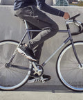 Side view of person on bike using Toe Clips For Bike Pedals With Wide Opening For Easy On Off Comfort And Convenience Durable Foot Straps