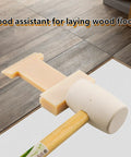 4 In 1 Laminate Floor Installation Tool Nylon Tapping Block With Diagonal U V And L Grooves in use with mallet on wood floor