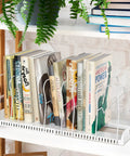 Built Tough Expandable Pan Rack With Ten Adjustable Compartments Heavy Duty Kitchen Pot Organizer with ten books organized upright.