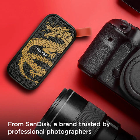 Dragon Edition 1TB Portable SSD with USB-C next to camera on red background for fast backups with updated firmware