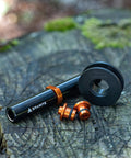 Dummy Hub Axle Chain Keeper For 12mm Thru Axle And QR Frames, black and orange pieces on a wooden surface