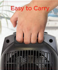 Hand holding Portable Desk And Room Space Heater With Carry Handle, 1500W, Lightweight 2.8 Lb Personal Heater For Easy Transport