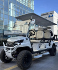 Rock Solid 6 Seater Electric Golf Cart With 48V Lithium Battery And 14 Inch Off Road Tires White leisure vehicle parked in urban setting.