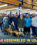 Group of workers with a dog in a workshop, captioned 'Assembled in USA'
