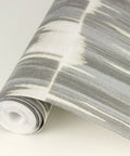 Serendipity Shibori Wallpaper In Misty Blue Gray With Faux Grasscloth Texture Raised Ink Design Washable And Strippable Non Woven Material Twenty Point Nine Inch Repeat On A Thirty Three Foot Roll, close-up view of the textured pattern on a rolled wallpaper.