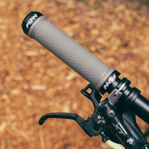 Mounted double lock on clamp mountain bike grips with diamond pattern for MTB and BMX 22 mm inner diameter, gray focus on handlebar