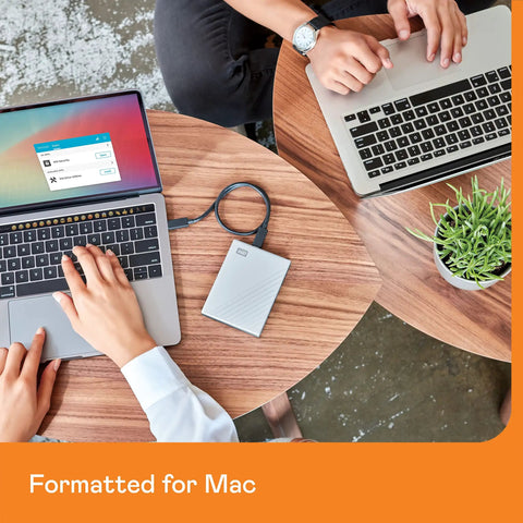 Person using 5TB My Passport Ultra For Mac Portable External Hard Drive With USB C And USB 3.1 on macOS laptop.