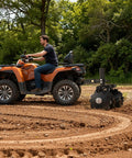 Man using ATV with Heavy-Duty 28 Inch Disc Plow Harrow With Universal 2 Inch Receiver Hitch Pull-Behind Plow