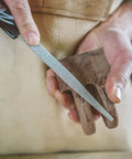 User shaping wood with Heavy Hitter Flat Hand Rasp With Tungsten Carbide Coating And Ergonomic Soft Grip Handle For Workhorse Woodworking Shaping And Smooth Multidirectional Cutting 11 Inch Length.