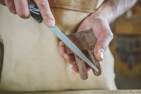 Pro Grade Heavy Duty Eight Inch Half Round Hand Rasp With Slick Ergonomic Soft Grip Handle and Tough Tungsten Carbide Coating in use on wood.
