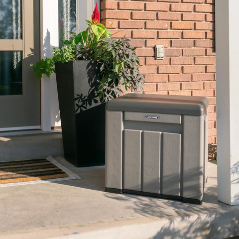 Versatile Outdoor Storage Cube Deck Box Doubles As Cozy Bench Seat And 25 Gallon Capacity Weather Resistant Patio Organizer near a front door.