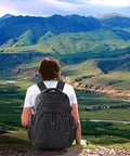 Person hiking with Go-To Travel Laptop Backpack 17.3 Inch XL With Hard Shell Saferoom And RFID Pockets, scenic mountain view