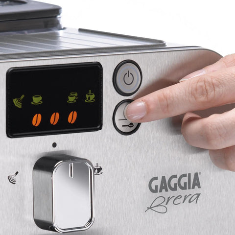 Super Automatic Espresso Machine With One Touch Brewing Delivers Solid Daily Grinds And Straight Fire Shots That Hit Different Every Time In A Sleek Silver Body Made For Zero Hassle Home Brewing, control panel close-up with hand pressing button.