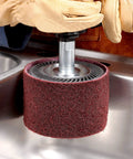 Gloved hands using Surface Conditioning Belt For Metal Finishing 1/2 In By 18 In Nonwoven A CRS Grade on stainless steel surface