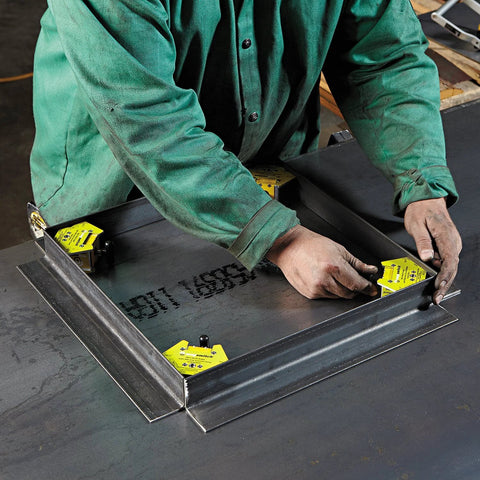 Magswitch Mini Multi-Angle Welding Magnet with yellow clamps mounted on a steel frame.