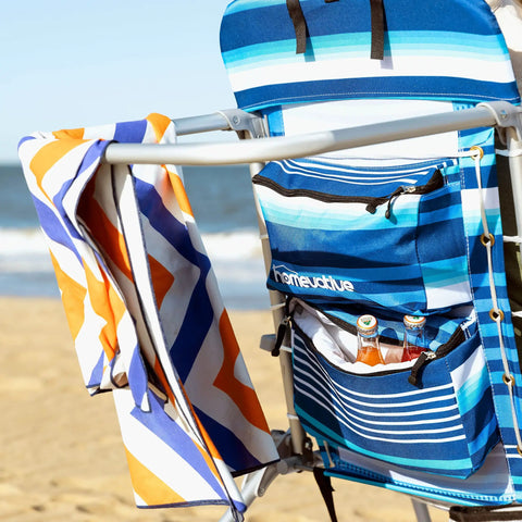 Folding Tall Backpack Beach Chair With Five Positions Towel Bar Cooler in High Tide Blue by the beach with storage pouch.