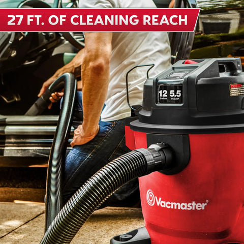 Heavy Duty 12 Gal Wet Dry Shop Vac With Beastly 5.5 Peak HP Motor And Nine Must Have Cleaning Attachments For Cranking Nasty Garage Jobs And Spills Features Classic Red Plastic Design, shown in use with a long hose.