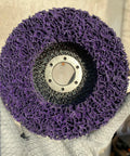 Front view of a strip disc with purple abrasive surface. Five Pack Strip Discs Four And A Half Inch By Seven Eighth Inch Stripping Wheel For Angle Grinder With Silicon Carbide Abrasive For Cleaning Paint, Rust, Oxidation And Welds.