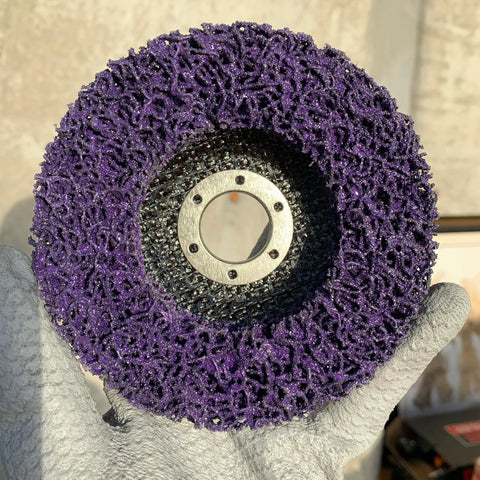 Front view of a strip disc with purple abrasive surface. Five Pack Strip Discs Four And A Half Inch By Seven Eighth Inch Stripping Wheel For Angle Grinder With Silicon Carbide Abrasive For Cleaning Paint, Rust, Oxidation And Welds.