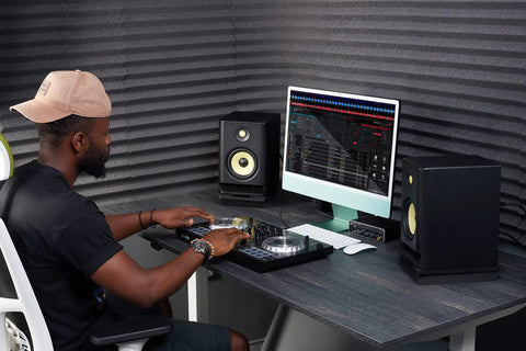 Acoustic Isolation Platform For 5 Inch Studio Monitors, Thick High Density Foam Riser, 9.5 By 7 By 1.8 Inches, Two Piece Speaker Pad Reducing Vibration For Crisp, Clear Sound In Home Studio under speakers on a desk in a home studio setup.