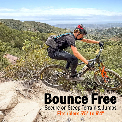 Mountain biker using mountain bike hydration pack with 3L bladder and 10L storage for trail rides, lumbar support, charcoal color.