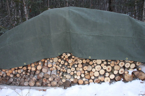 Heavy Duty Green Canvas Tarp 7x9 Dry Top Ultra Thick 16 To 18 Oz Industrial Cover protecting stacked firewood outdoors.