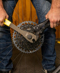 Vise Whip II Cassette Removal Tool For Bikes in use, heat-treated steel grips 9 to 23 tooth gears during maintenance.