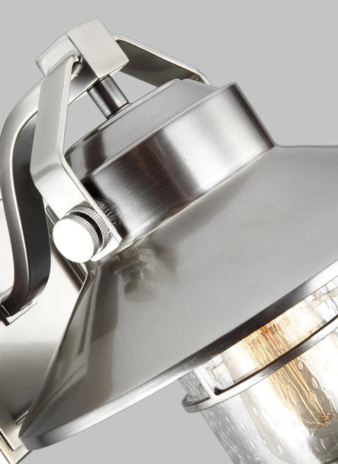Close-up of Boynton Outdoor Wall Light With Transitional Stone Finish, featuring metal fixture detail and glass bulb cover.