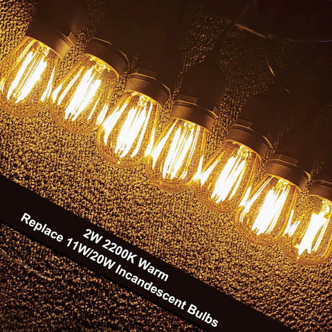 S14 Outdoor String Light Bulbs Replacement 15 Pack, Retro Warm Amber Glow 2200K LED Edison Bulbs on textured surface