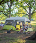 Family camping with Instant Cabin Tent for 9 People, Large Multi Room Family Pop Up Shelter With 2 Minute Setup in a forest setting.