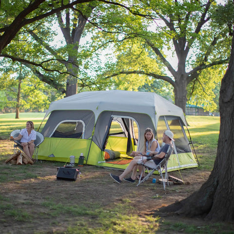 Family camping with Instant Cabin Tent for 9 People, Large Multi Room Family Pop Up Shelter With 2 Minute Setup in a forest setting.
