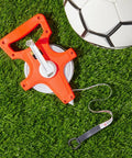 Retractable Open Reel Tape Measure 30 Meter Long Jump Track And Field Tool with soccer ball on grass