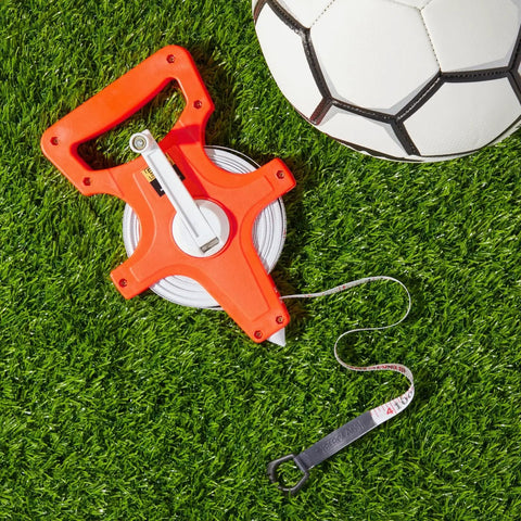Retractable Open Reel Tape Measure 30 Meter Long Jump Track And Field Tool with soccer ball on grass