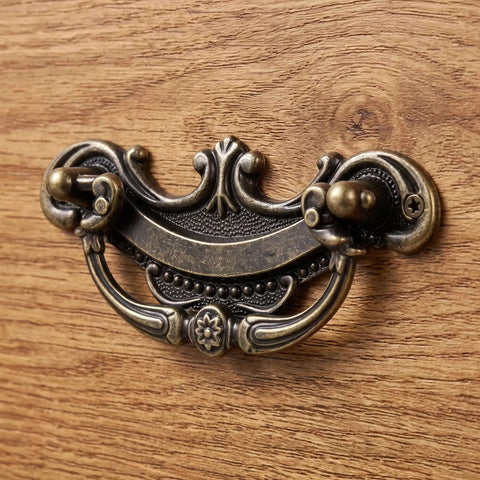 Antique Brass Drop Bail Drawer Pulls 3.5 inch center to center with vintage cabinet pulls on wooden dresser.